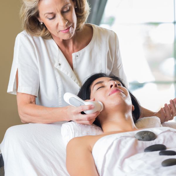 Customers engaging in an interactive salon experience with facial toning treatments